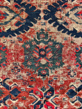 an antique sumac runner with a red field and blue, pink and green accents