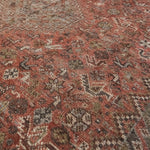 Close-up of a patterned rug with earthy tones