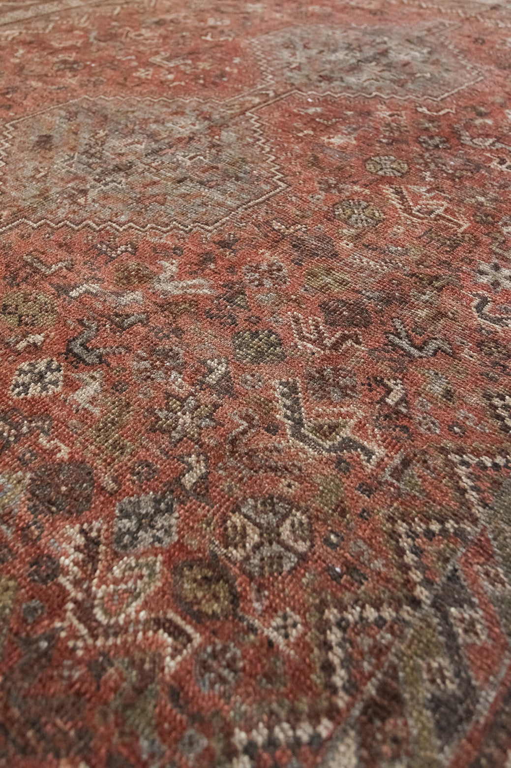 Close-up of a patterned rug with earthy tones