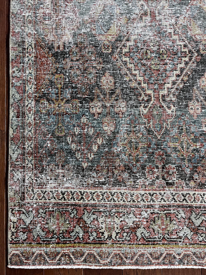 an antique chosakan runner with a faded turquoise/teal palette and terracotta accents