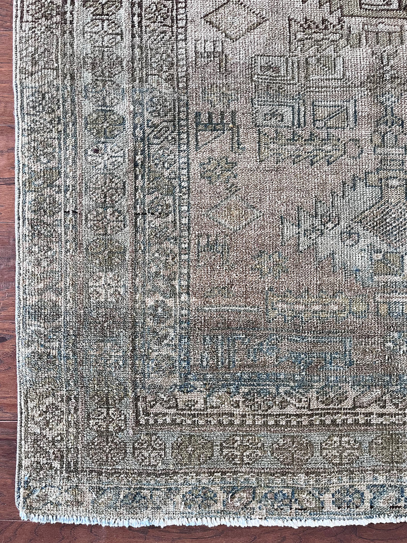 an antique Heriz runner circa 1900 with a neutral grey taupe field and light blue and green accents