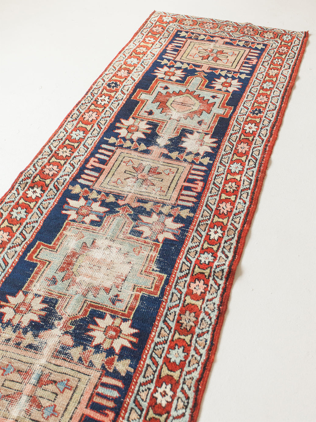Decorative rug with intricate patterns on a white background