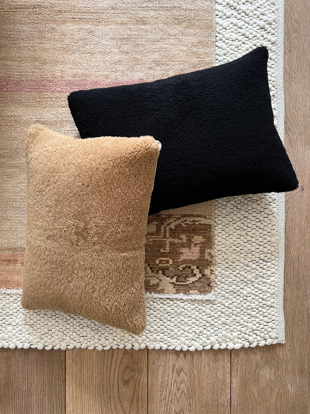 a black shearling lumbar with a plush velvet backing and exposed brass zipper