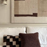 a square shearling pillow in chocolate brown shearling