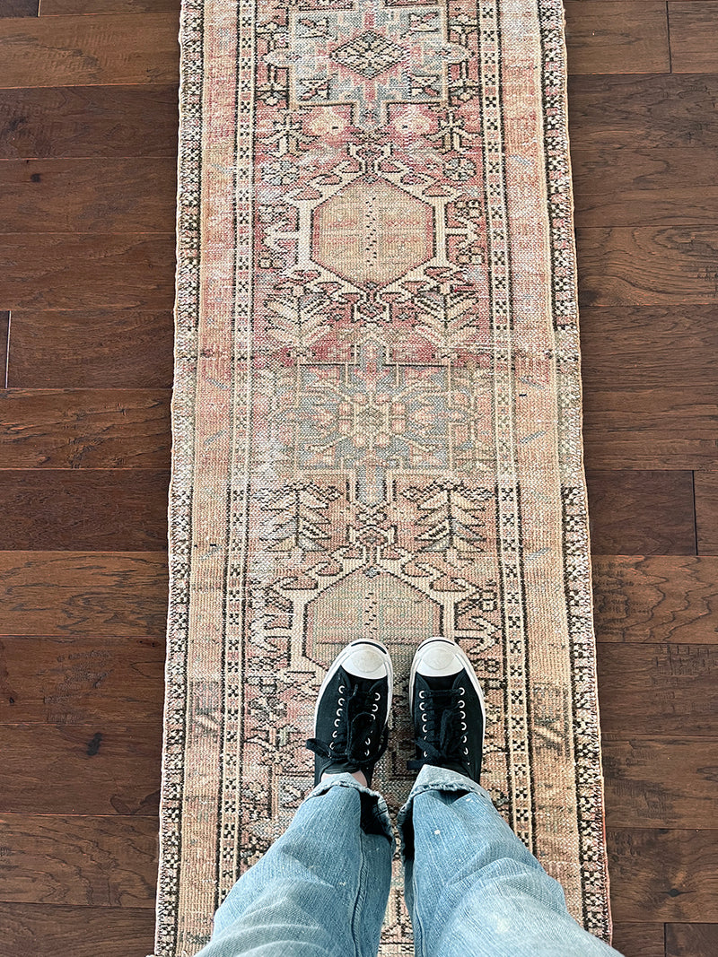 a vintage heriz runner with soft pink undertones, light turquoise and icy blue hues