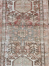 a vintage heriz runner with soft pink undertones, light turquoise and icy blue hues