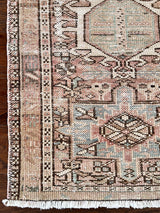 a vintage heriz runner with soft pink undertones, light turquoise and icy blue hues