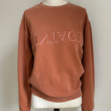 a comfy easy to wear sweatshirt in wam terracotta with 'vintage' embroidered upside down for an abstract look