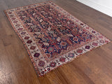 an antique qashqai rug with a midnight blue field and white, yellow and red accents 