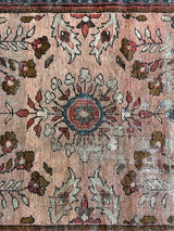 an antique mahal rug with a soft pink field and a pretty blue and brown floral pattern