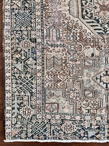 a large heriz runner with a neutral taupe field and dark blue medallions 