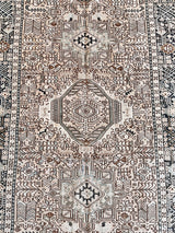 a large heriz runner with a neutral taupe field and dark blue medalli