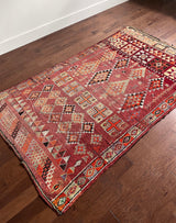 a vintage moroccan rug with a cherry red and pink palette and pretty lilac accents