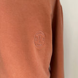 a comfy easy to wear sweatshirt in wam terracotta with 'vintage' embroidered upside down for an abstract look