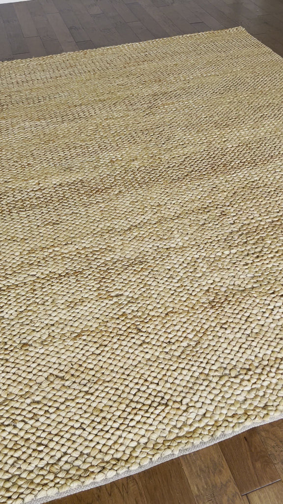 a chunky braided jute rug with ombre caramel tones