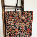 an overnight tote bag made with antique rug and suede