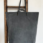 an overnight tote bag made with antique rug and suede