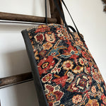 an overnight tote bag made with antique rug and suede