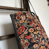 an overnight tote bag made with antique rug and suede
