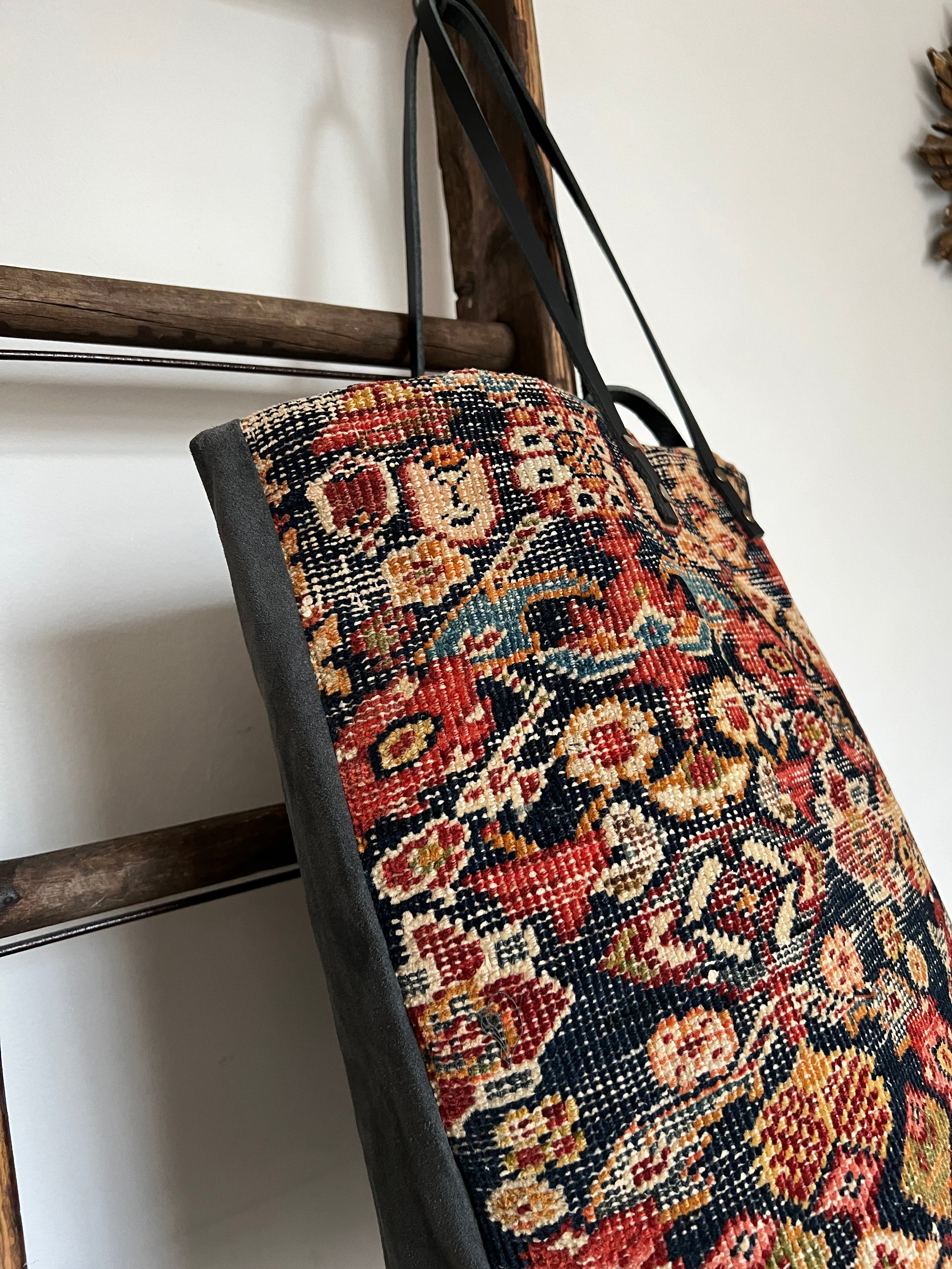 an overnight tote bag made with antique rug and suede