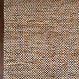 a chunky braided jute rug with ombre caramel tones