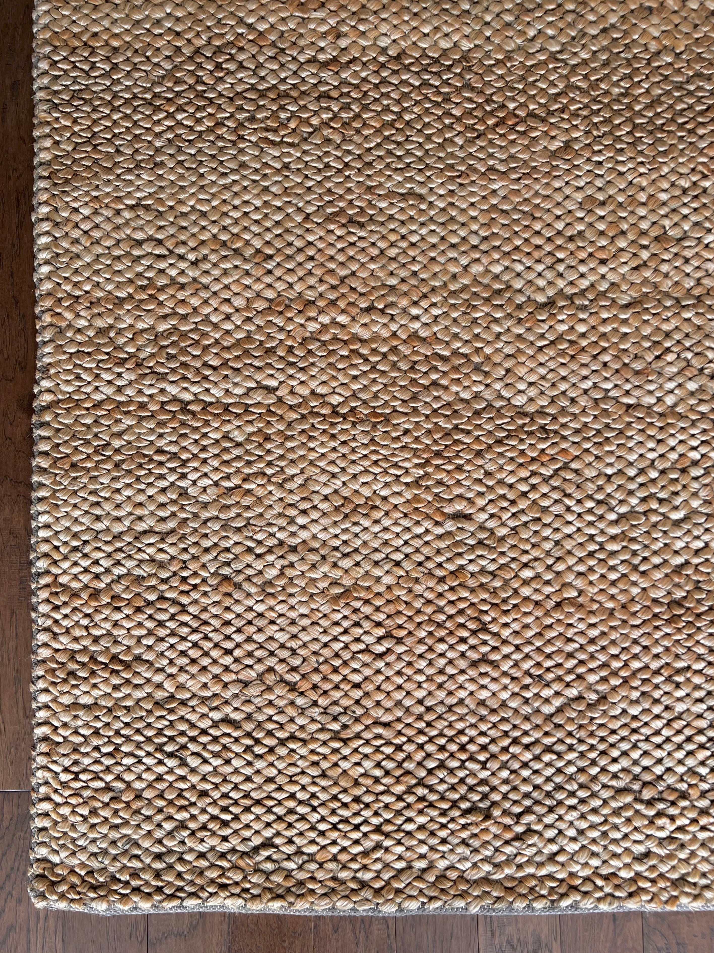 a chunky braided jute rug with ombre caramel tones