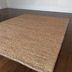 a chunky braided jute rug with ombre caramel tones