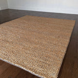 a chunky braided jute rug with ombre caramel tones