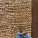 a chunky braided jute rug with ombre caramel tones