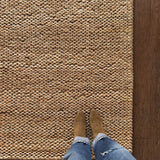 a chunky braided jute rug with ombre caramel tones