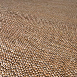 a chunky braided jute rug with ombre caramel tones