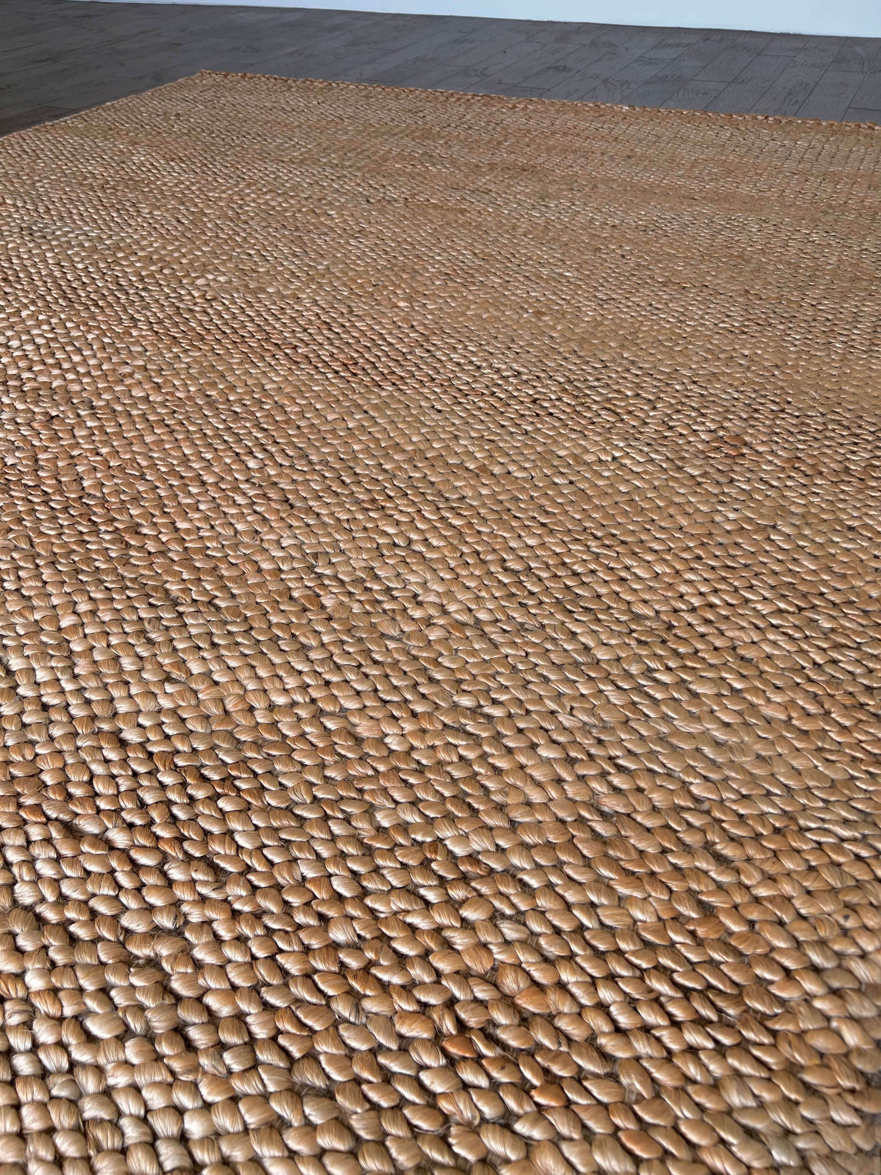 a chunky braided jute rug with ombre caramel tones