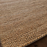 a chunky braided jute rug with ombre caramel tones