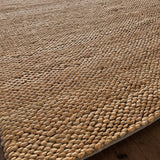 a chunky braided jute rug with ombre caramel tones