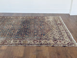 an antique Malayer rug with blue palette and cream trellis details