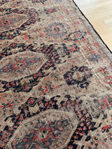 a very fine antique sumac rug with a taupe field and dark blue and bright pink accents