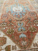 an antique malayer rug with a coral field and icy blue accents